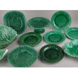 A collection of majolica green leaf pattern tableware to include a Wedgwood leaf shaped dish and
