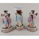 A bisque porcelain centrepiece with bowl supported by three classical figures 30.5cm high,