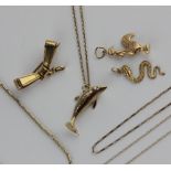 A 9ct gold dolphin charm, together with a neck chain detailed '9ct', a ribbon brooch detailed '375',