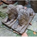 A pair of composite garden ornaments in the form of recumbent lions approx 40cm high