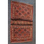 A small saddlebag, possibly Kurdish, red ground with geometric diamond motifs 94cm by 56cm (a/f)