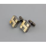 A pair of Swedish cufflinks the bold square fronts with gilt geometric motifs and with folding