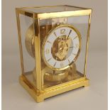 A Jaeger Le Coultre Atmos mantle clock, with gilt edged white circular chapter ring 22cm high,