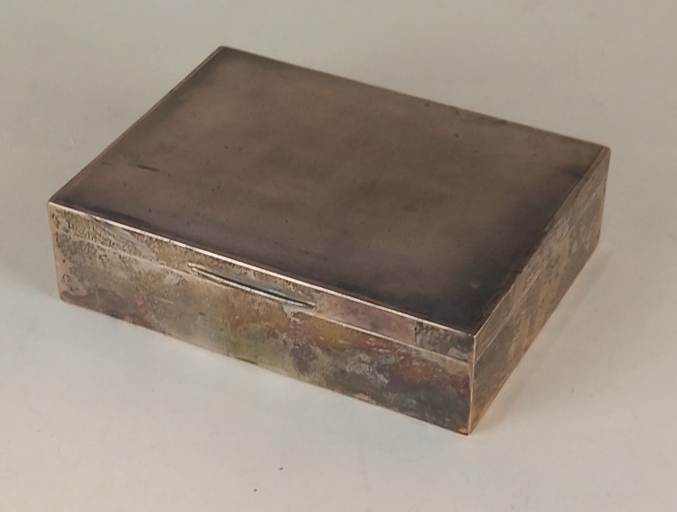 A Queen Elizabeth II silver rectangular cigarette box with engine turned lid, maker J B Chatterley &