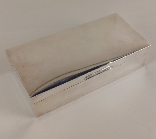 A Garrard & Co. silver cigarette box rectangular hinged top enclosing fitted wood interior,