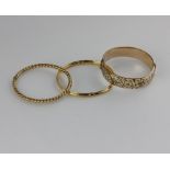 A gold hinged bangle faintly stamped '585', 11.3g, together with a rolled gold hinged bangle with