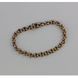 A 9ct gold brick link bracelet, comprising three rows of hollow links, fastened by a box clasp 11.
