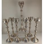 A set of seven Gothic style plated metal candlesticks, comprising six 49cm high and one 62.5cm