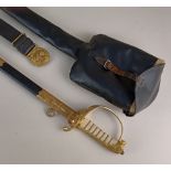 An Elizabeth II Royal Naval officer's sword by Gieves of London, with scabbard, outer bag, and