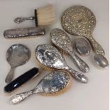 A collection of eight assorted silver dressing table brushes and two hand mirrors