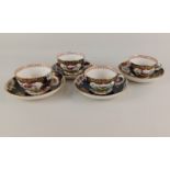 Four Worcester style porcelain tea cups and saucers decorated with fancy birds and flowers in gilt
