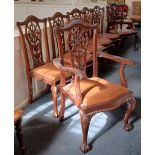 A set of seven Chippendale style carved mahogany dining chairs, to include two carvers, carved