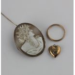 A gold mounted oval shell cameo brooch carved with a portrait of a lady, a 9ct gold wedding ring
