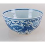 A Chinese blue and white porcelain bowl decorated with lions and flowers amongst foliage, with