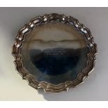 A George VI silver card tray with pie crust border and presentation inscription, maker Walker and