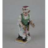 A Dresden porcelain figure representing December 10cm high