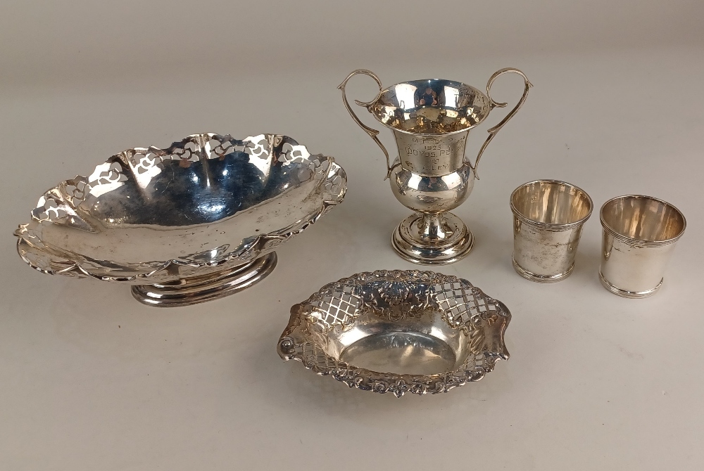 A George V silver oval pedestal dish with pierced border, pair of silver tots, pierced oval bonbon