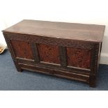 An 18th century oak linen chest / coffer, the carved front with three panels inlaid with marquetry