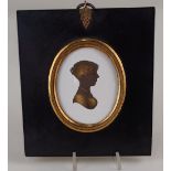 John Miers (c.1758-1821), an oval bronzed silhouette profile portrait of a young lady to the