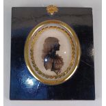 A late 18th / 19th century oval portrait silhouette of a lady painted on convex glass with gilt