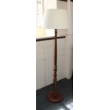 A mahogany standard lamp with turned stem on circular base 140cm high