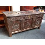 A carved oak coffer three panelled front with floral motifs, on block feet, width 120cm height 57cm