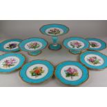 A 19th century porcelain dessert service painted with flowers within a turquoise and gilt border,