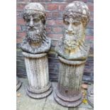A pair of composite garden ornaments in the form of two busts of classical bearded men on column