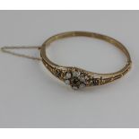 A Victorian style opal and sapphire hinged bangle, in fitted case