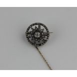 A Victorian target brooch, set with a central old cut mine diamond surrounded by rose cut