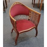 An Edwardian inlaid mahogany tub chair with red upholstered back and seat, and slatted supports,