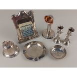 A George V silver inkwell a desk calendar, ashtray, pair of miniature cherub vases and a silver