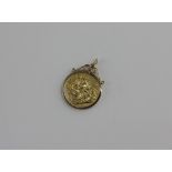 An Edward VII gold sovereign dated 1908, in loose 9ct gold pendant mount