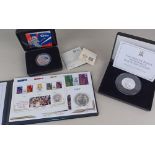 A Royal Mint cased silver Britannia coin, a Jubilee Mint Queen Elizabeth cased two ounce silver