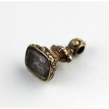 A Victorian foil backed pale amethyst pendant fob seal decorated with flowers and shells, the base