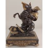 A bronzed metal figure of Napoleon seated on a rearing horse in a battlefield, on four brass feet,