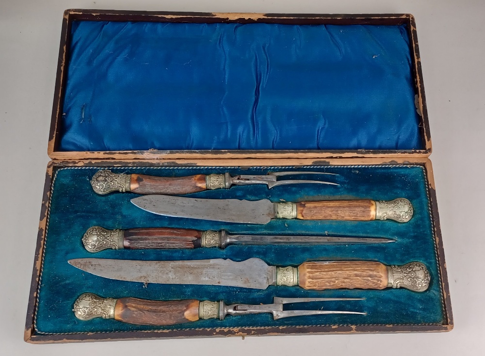 A Victorian five piece carving set with metal mounted horn handles in fitted case (a/f) blades