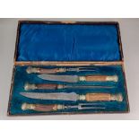 A Victorian five piece carving set with metal mounted horn handles in fitted case (a/f) blades