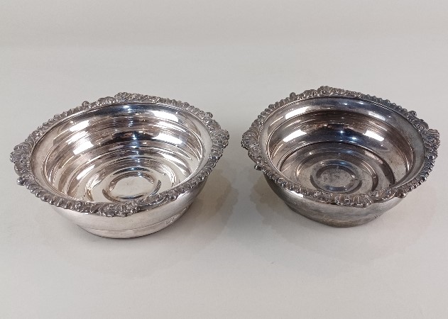 A pair of silver plated bottle coasters by Israel Freeman and Sons, with cast scroll and gadrooned