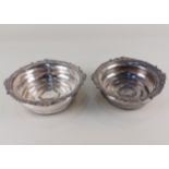 A pair of silver plated bottle coasters by Israel Freeman and Sons, with cast scroll and gadrooned