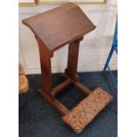 An oak prie dieu with a sloping top and upholstered kneeling pad width 46cm, height 77cm