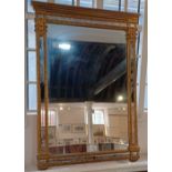 A rectangular gilt framed wall mirror with eight border panels width 65cm, height 91cm