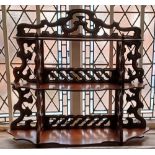 A set of mahogany three-tier hanging open wall shelves with fret cut back and supports width 73cm,