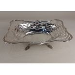 An Edward VII silver bon bon dish with pierced decoration, raised on four feet, Birmingham 1904 (