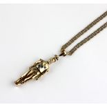 A 9ct gold pendant in the form of an articulated jockey figure set with three blue stones, length