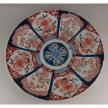 A Japanese Imari porcelain charger, with panels of floral decoration 47cm diameter (a/f)