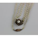 A two row necklace of graduated cultured pearls on a gold and cultured pearl clasp designed as a