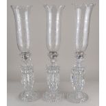 Three Baccarat glass candlestick lustres with engraved storm shades and cut glass drops 55cm high