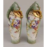 A pair of German porcelain blush ivory vases, each with applied sinuous gilt and green lily to