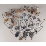 A collection of silver plated decanter labels and bottle stoppers various styles and designs,